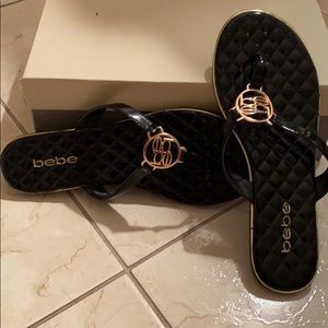 Bebe Black patent leather flip flops